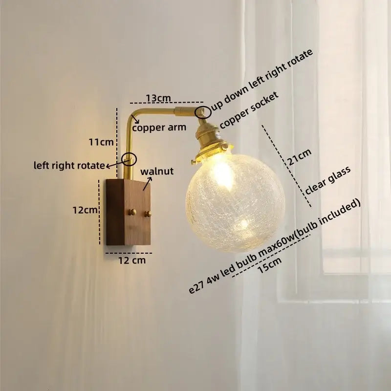 Modern walnut and copper wall sconce with warm brass arm and clear glass crackle globe for stair lighting