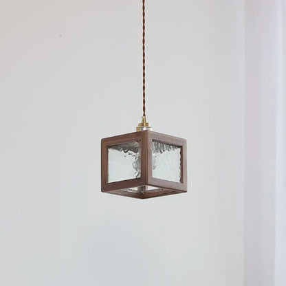 Modern walnut wood pendant light with clear glass textured panels and brass fixture for dining room lighting