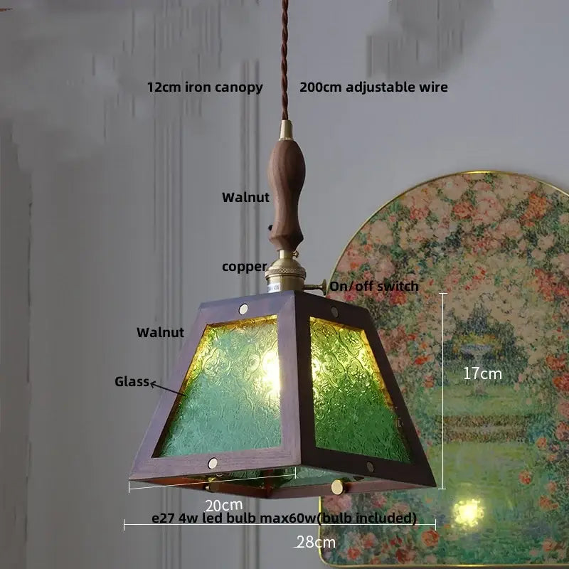 A modern walnut wood pendant light with green textured glass panels and copper accents for dining room use