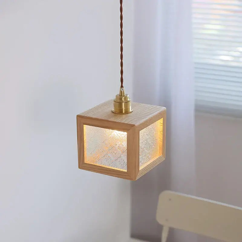 Modern walnut wood pendant light with clear glass frosted panels and brass fixture for dining room illumination