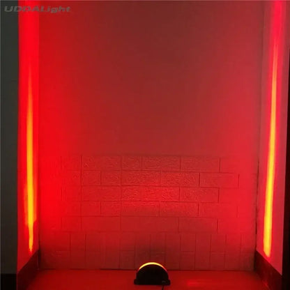 A sleek black led spotlight with a curved dome head casting red and orange beams for decorbites led window lighting decor