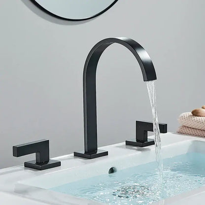 Black matte basin faucet with curved spout and square handles featuring decorbites dual handle gold design