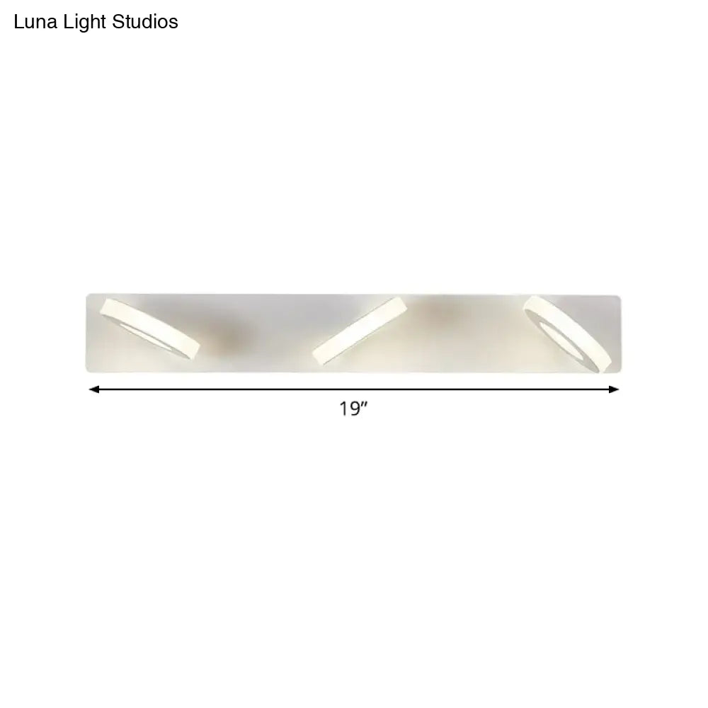 Modern white 3-light adjustable wall light fixture with three sleek angled circular led lights for bathroom use