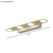 Modern white 3-light led vanity wall light with circular bulbs providing warm white light for bathroom use