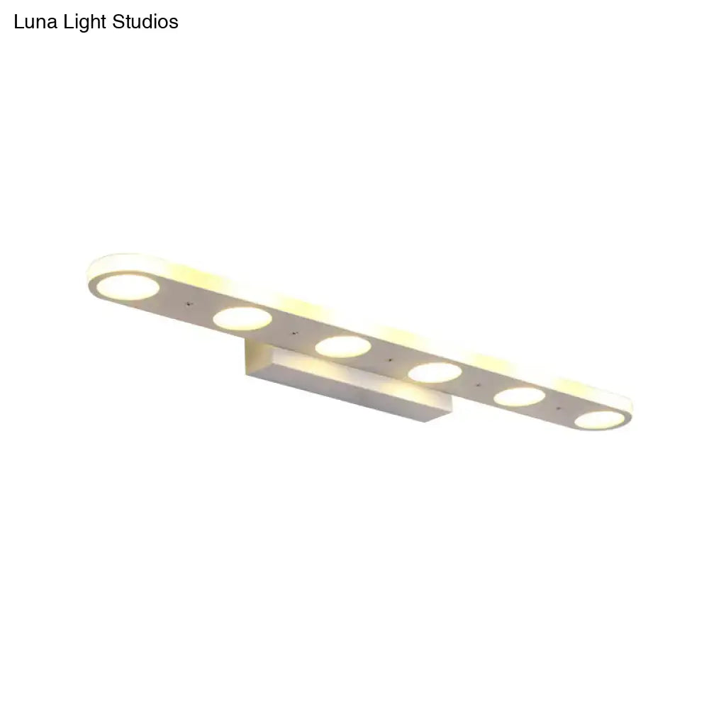 Modern white vanity wall light with six circular LED bulbs providing warm white light for bathroom use