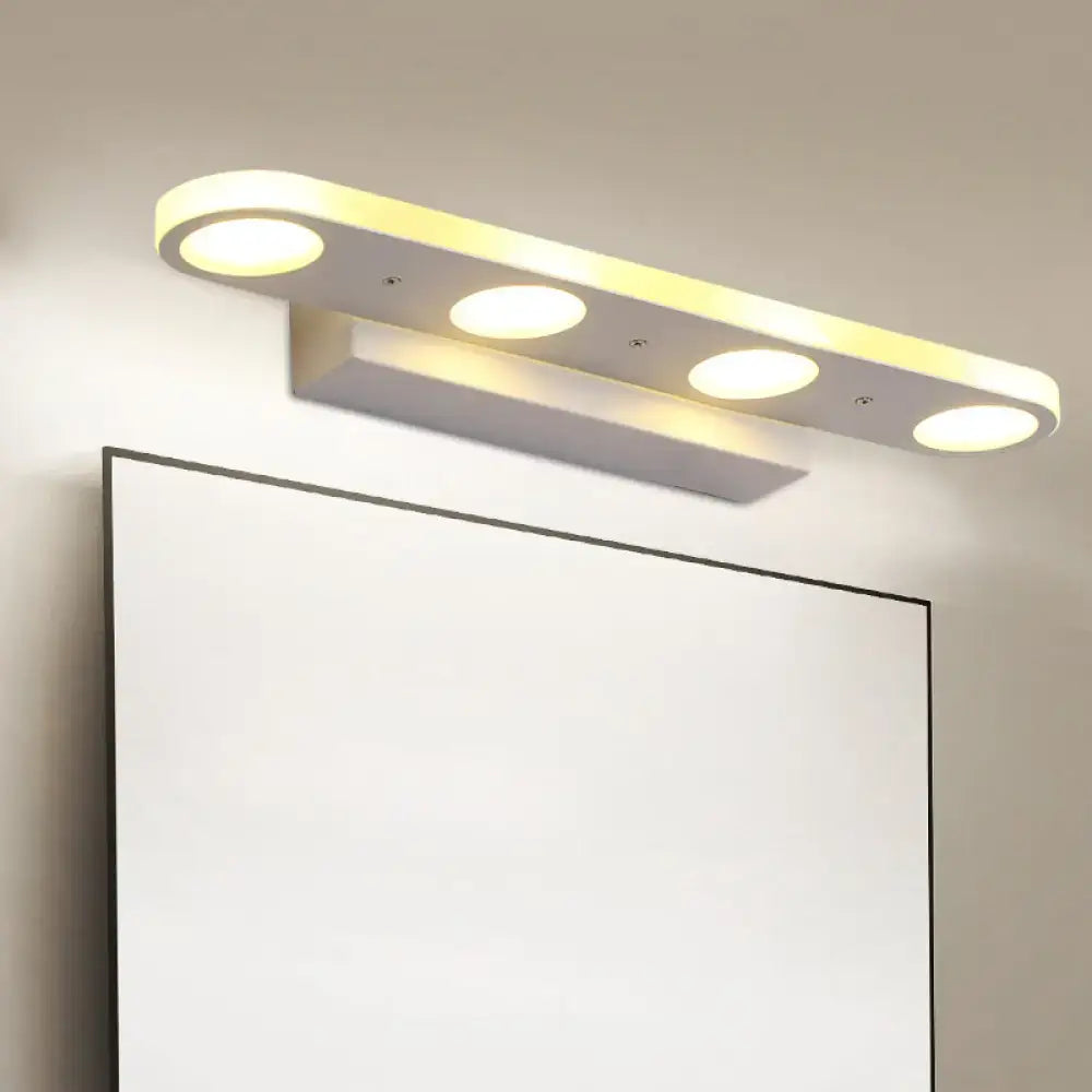 Modern white vanity wall light with four circular led bulbs providing warm white light in a sleek minimalist design