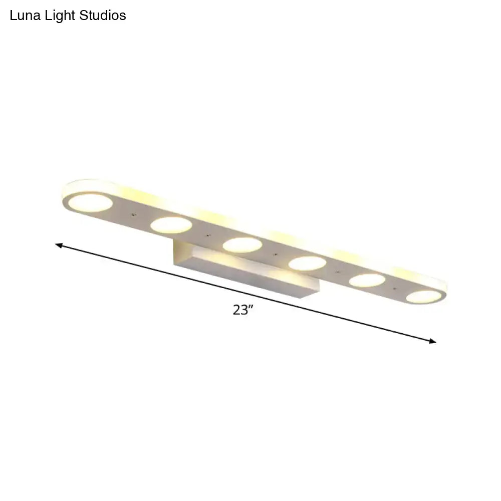 Modern white rectangular vanity wall light fixture with six circular led bulbs providing warm white light