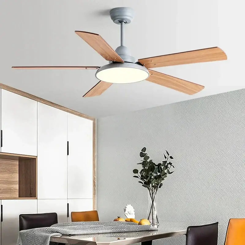 Modern white ceiling fan light with five light wood blades and matte gray housing featuring integrated led fan light