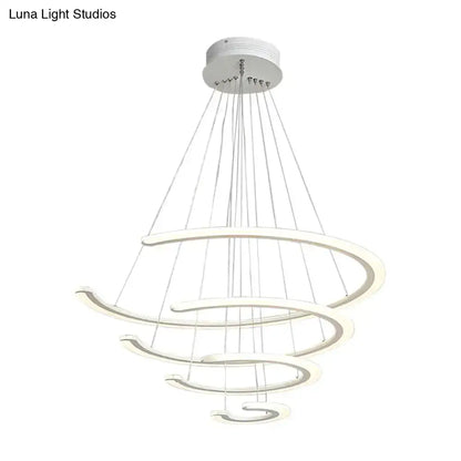 Modern white acrylic ring dining room chandelier with layered rings suspended by thin cables in warm white light