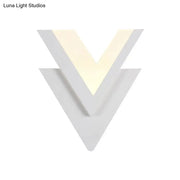 Modern white acrylic sconce light with v-shaped design and warm white glow for bedroom light fixture