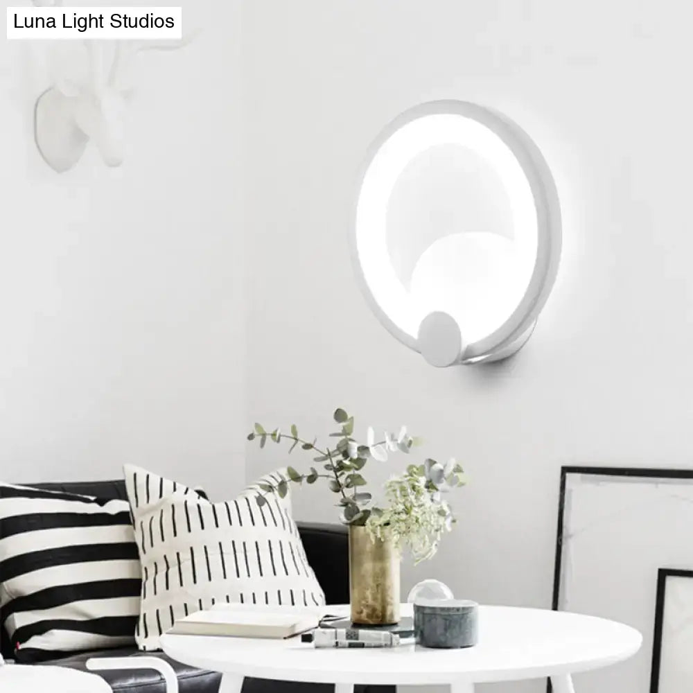 Modern white acrylic sconce light with circular minimalist design ideal for bedroom wall installation