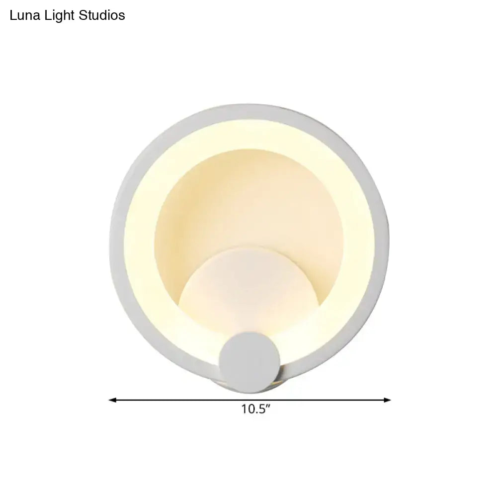 Modern white acrylic sconce light featuring circular matte white rings with soft warm led lighting for bedroom use