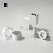 Modern white adjustable angle downlight with sleek design and metallic accents for living room spotlight fixture