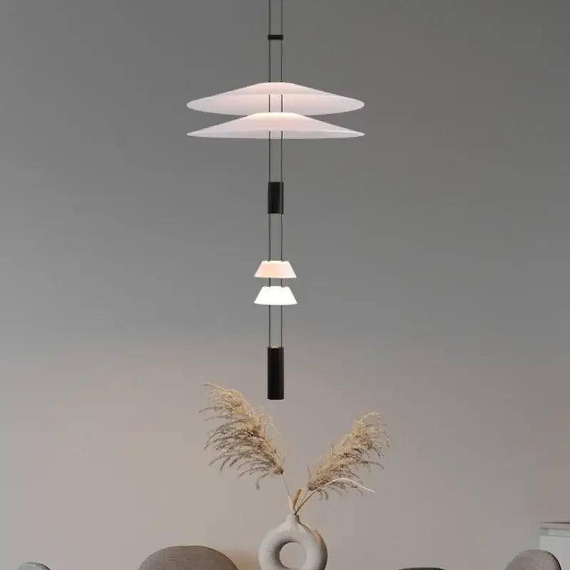 Modern white and black circular pendant light with tiered translucent disc shades and black cylindrical accents for dining room decorbites circular pendant