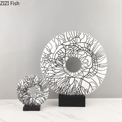 Modern white and black floral decorbites circle ornament with intricate patterns on a sleek black stand for living room decor