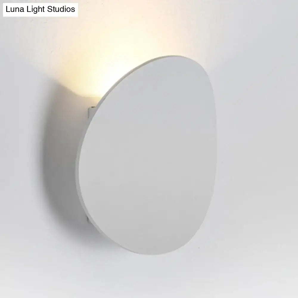 Modern white and black wall sconce in modern style emitting a warm soft glow for bedroom LED spotlight lighting