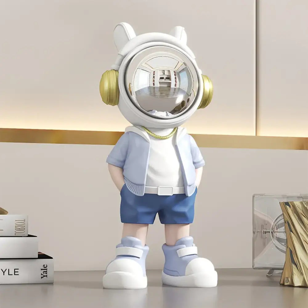 Modern white and blue astronaut resin sculpture with gold headphones and reflective visor for living room decor