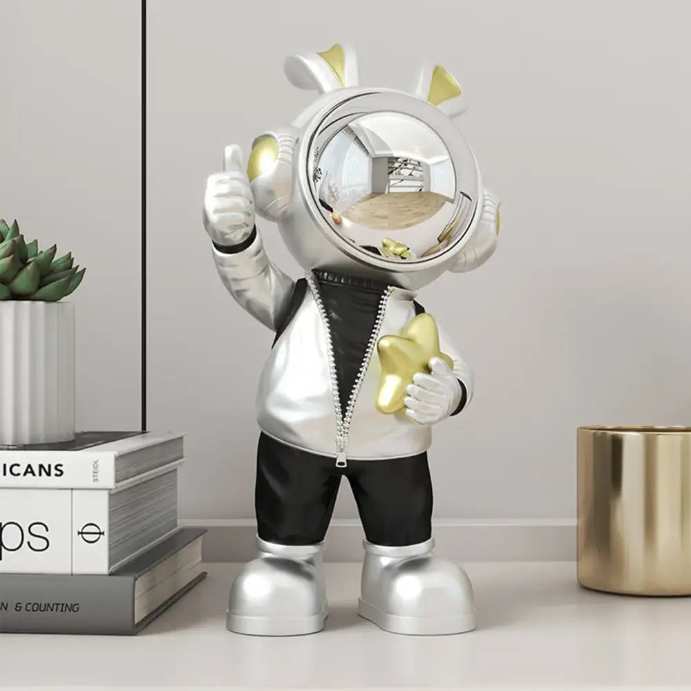 Modern white and blue astronaut resin sculpture featuring silver and gold resin astronaut holding a golden star for living room decor