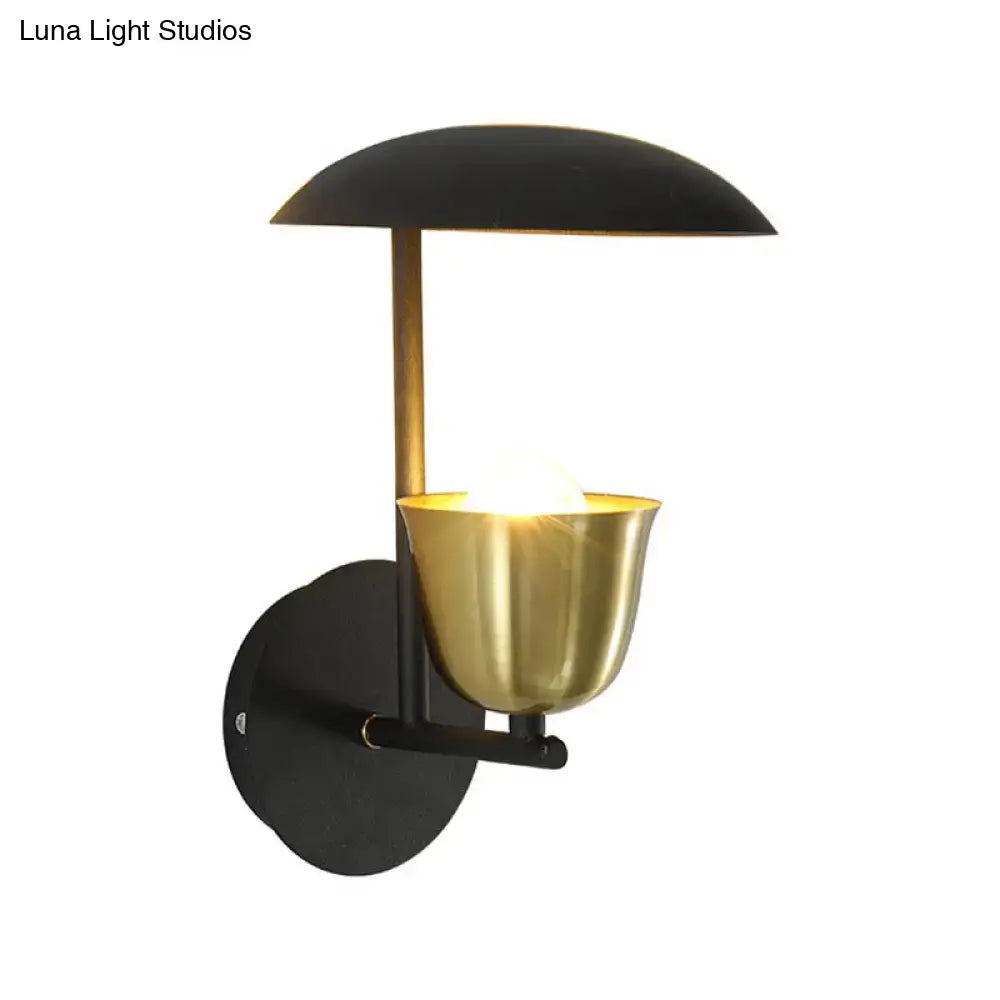 Modern white and brass bell metal sconce with a curved shade and cup-shaped light fixture for bedroom wall lighting
