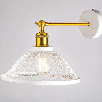 Modern white and brass iron net wall lamp with a gold arm and clear glass mesh shade for bedroom decorbites iron net