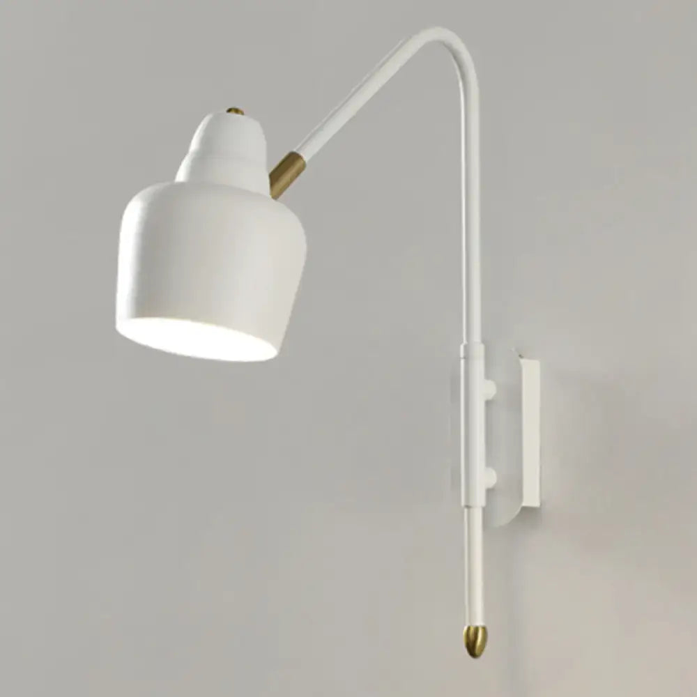 Modern white and brass v-shaped wall light with curved arm and brass accents ideal as a bedroom reading light type