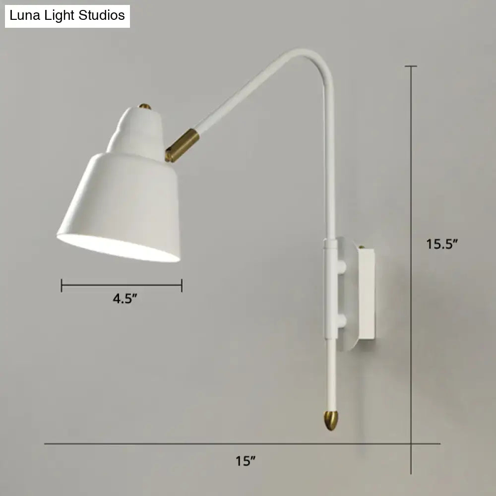 Modern white and brass v-shaped wall light with curved arm and brass accents ideal for bedroom reading light type
