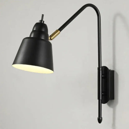 Black matte finished modern v-shaped wall light with brass joint and adjustable gooseneck arm for bedroom reading
