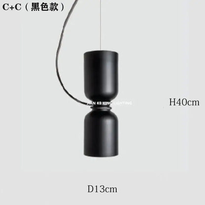 Black cylindrical pendant light with matte finish from decorbites designer iron chandelier for modern dining room decor