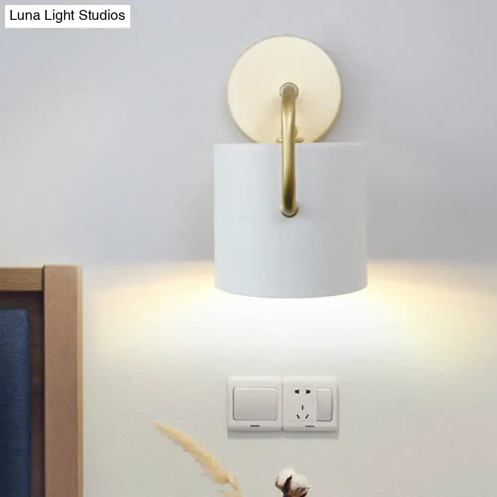 Modern white and gold cylinder wall lamp with a direct wired electric sconce light fixture and circular backplate