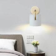Modern white and gold cylinder wall lamp with a direct wired electric sconce light fixture for bedroom use