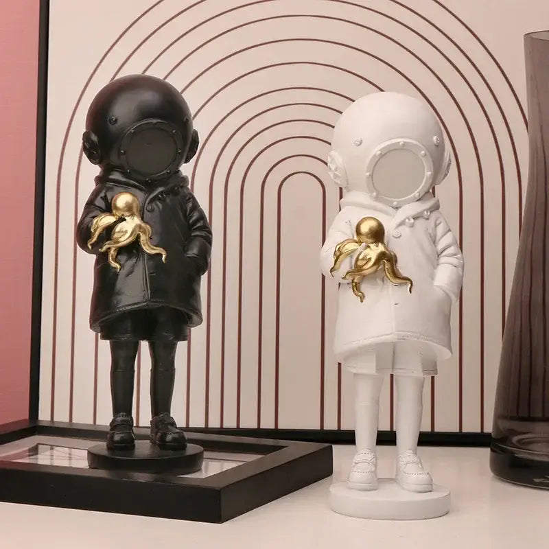 Modern white and gold deepsea diver sculpture featuring black and white astronaut figurines holding golden octopus decor