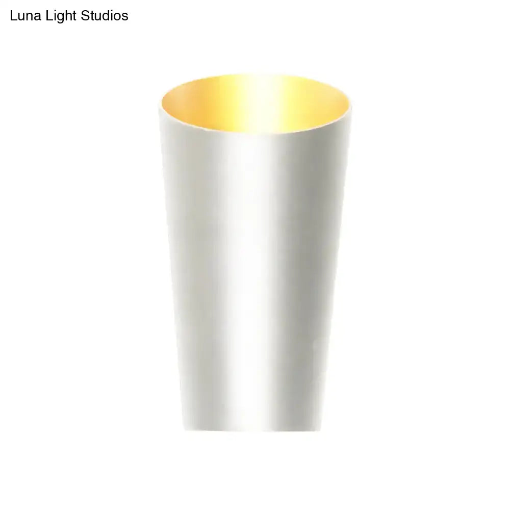 Modern led bedside sconce with a sleek cylindrical matte white exterior and reflective gold interior wall light