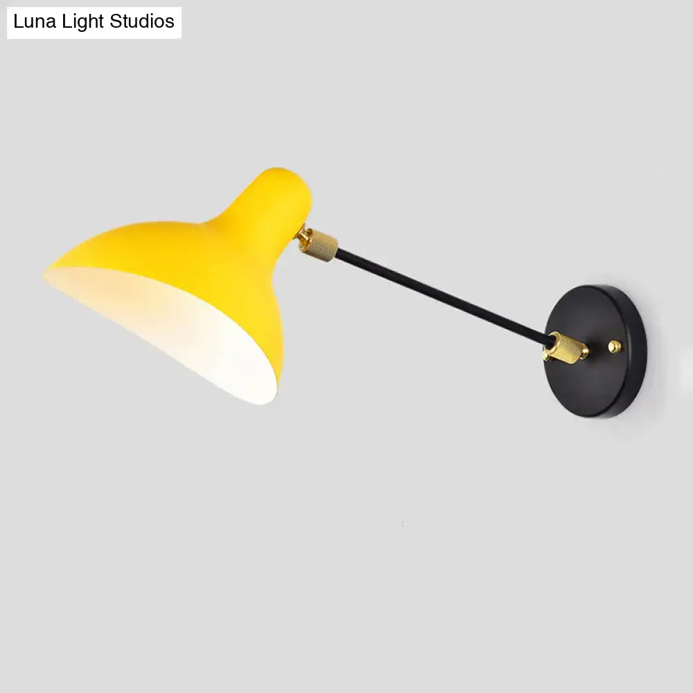 Modern white and gold wall mounted lamp with bright yellow matte sconce and black articulated arm for living room use