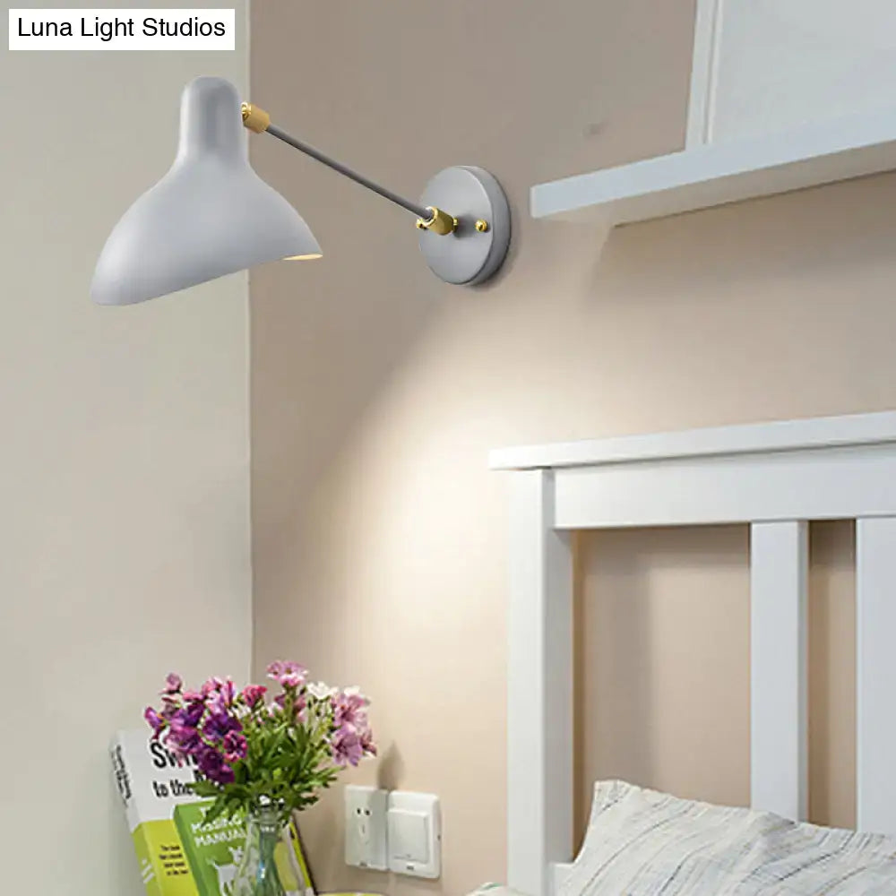 Modern white and gold wall mounted lamp with slender metallic arm and adjustable light for living room use