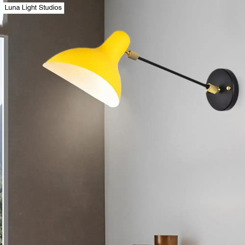 Modern living room wall mounted lamp with bright yellow matte shade, sleek black arm, brass accents, and adjustable light