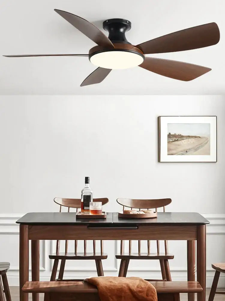 A modern ceiling fan with five dark brown wooden blades and black housing for bedroom use with led light