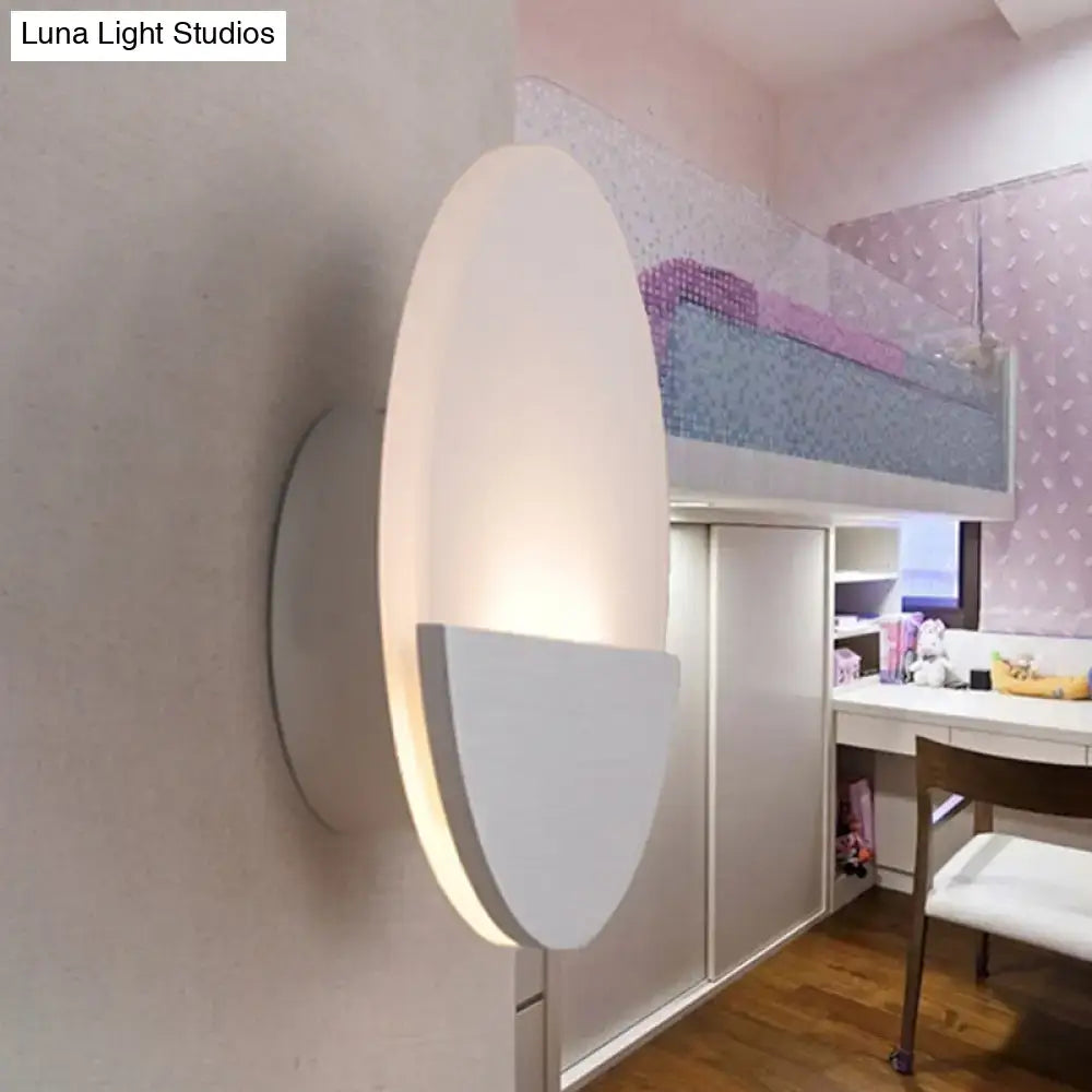 Modern white and silver led sconce light with a soft glowing warm light for bedroom illumination