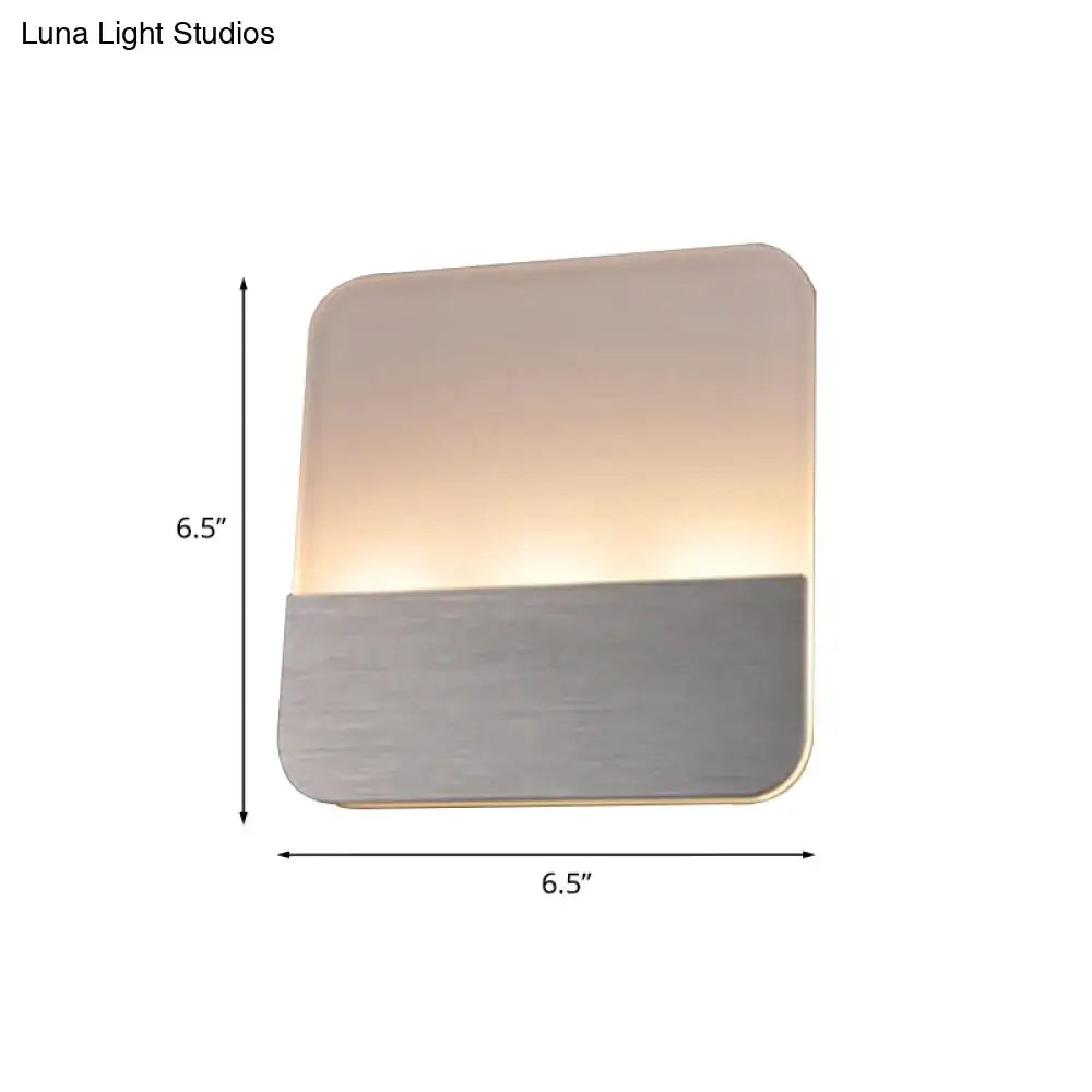 Modern white and silver led sconce light with brushed metallic base and warm glow for bedroom illumination