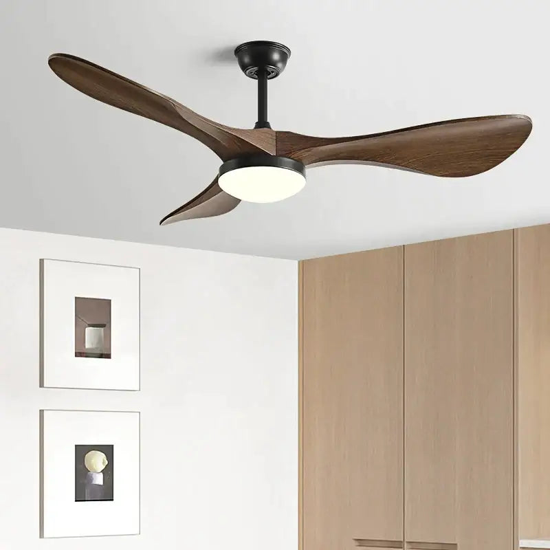 Modern ceiling fan with three dark wood blades and black housing featuring integrated LED light for living room use