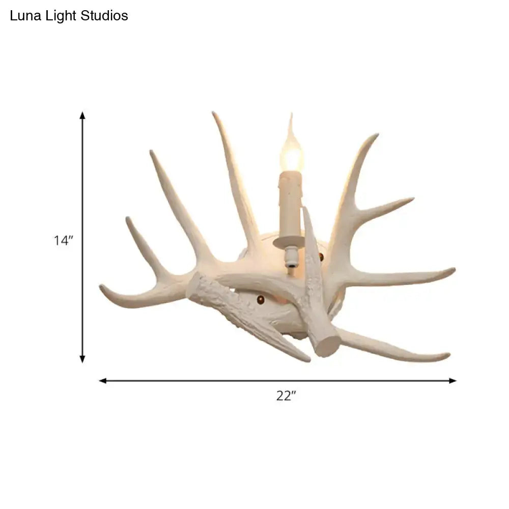 Modern white antler resin shade wall sconce featuring an intricately carved design with a candle-style bulb center
