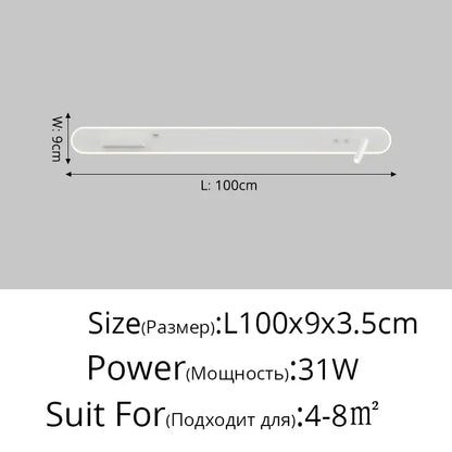 White minimalist soundbar with subtle control buttons beside modern white bedside wall lamp with wireless charging