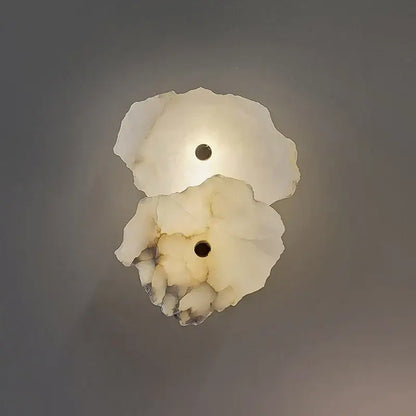 Modern white and beige stone brass wall lamp with translucent alabaster shell-like design and dark central accent for bedroom decorbites brass wall lamp