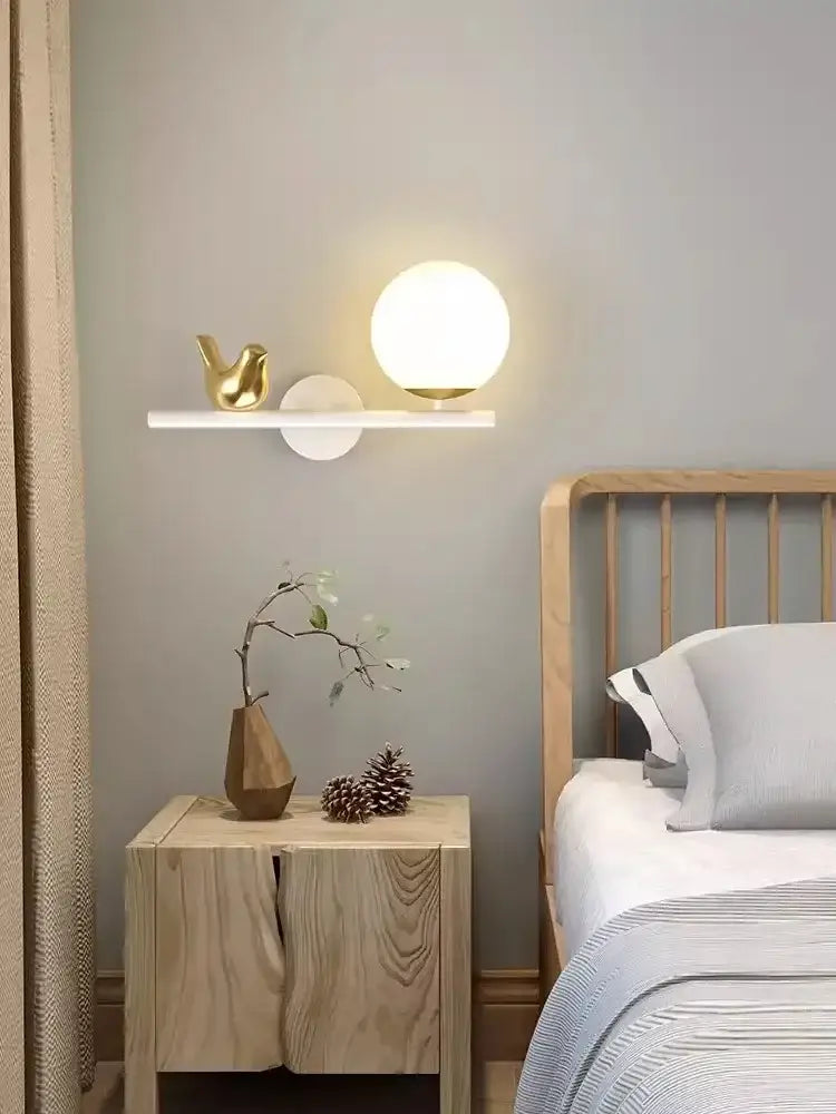 A modern white bird wall light with spherical frosted glass shade and gold base on a minimalist led shelf for living room decorbites bird wall lights
