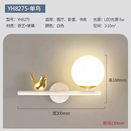 Modern white wall lights with spherical glass globe and gold bird figurine shelf for living room decorbites bird wall lights