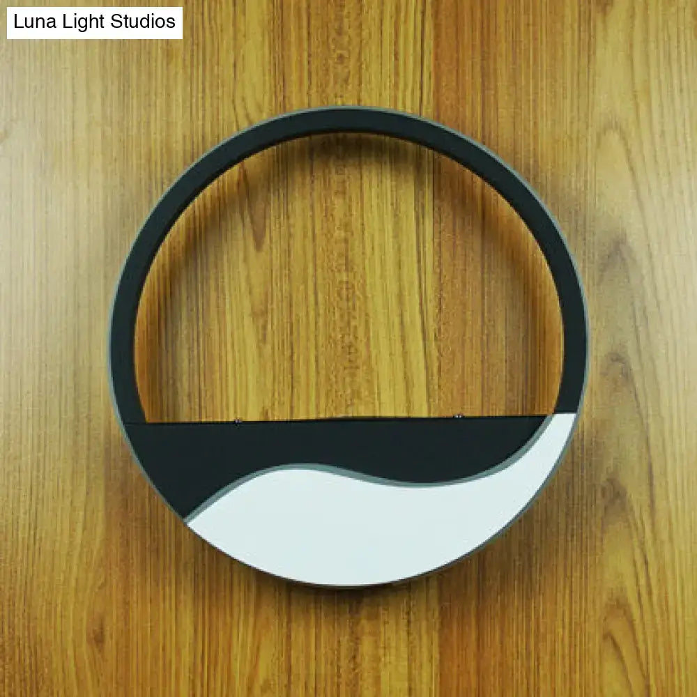 Modern black and white acrylic wall sconce with warm white light featuring a sleek minimalist circular ceiling design