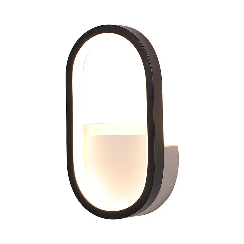Modern black-framed oval wall lamp with warm white led light diffuser for bedroom illumination
