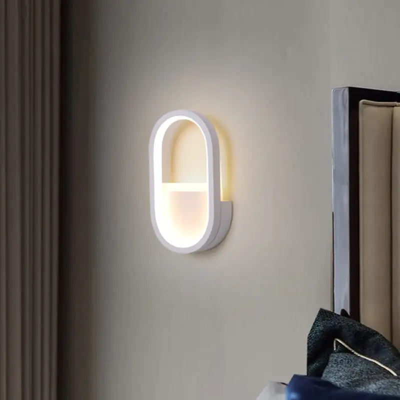 Modern white oval wall lamp with black ellipse frame featuring warm white led light for bedroom use