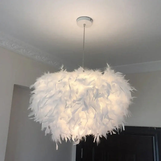 Modern white feather pendant light with soft cloud-like design hanging from ceiling for bedroom lighting