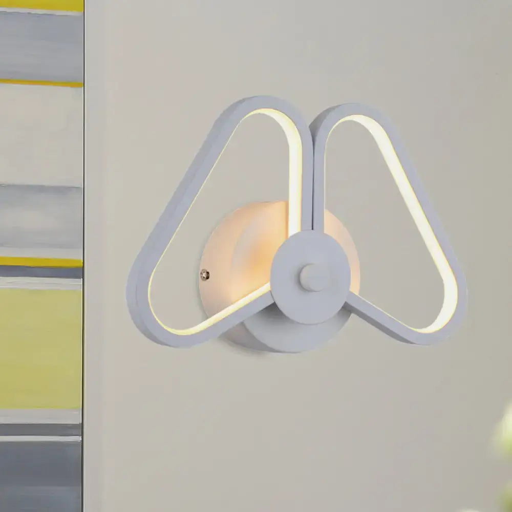 Modern white and black led triangle wall sconce with sleek butterfly-inspired design and glowing inner edges for living room lighting