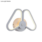 Modern white black led triangle wall sconce with sleek symmetrical design and warm ambient lighting for living room use